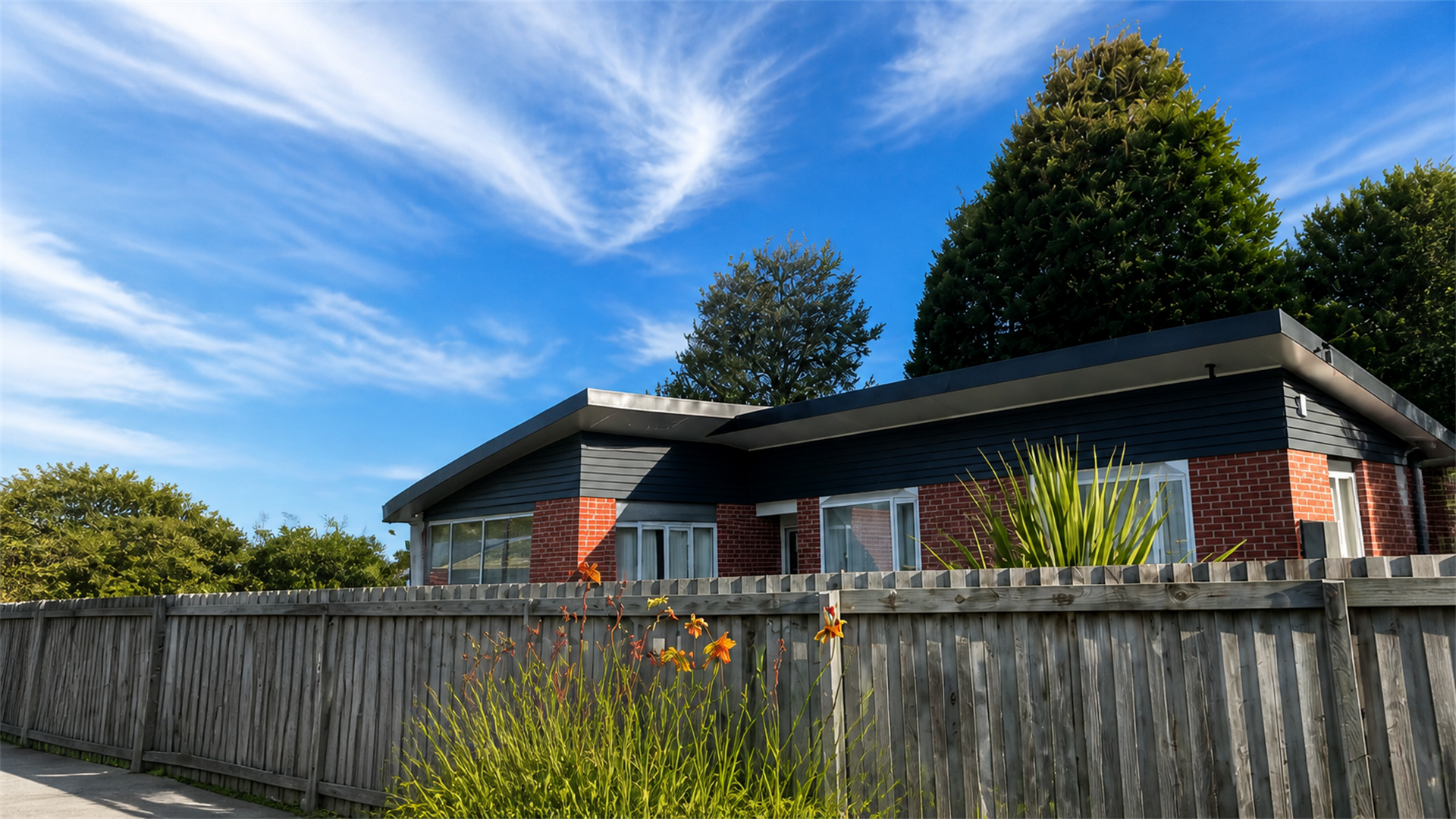 Freshly painted house under a bright Canterbury sky