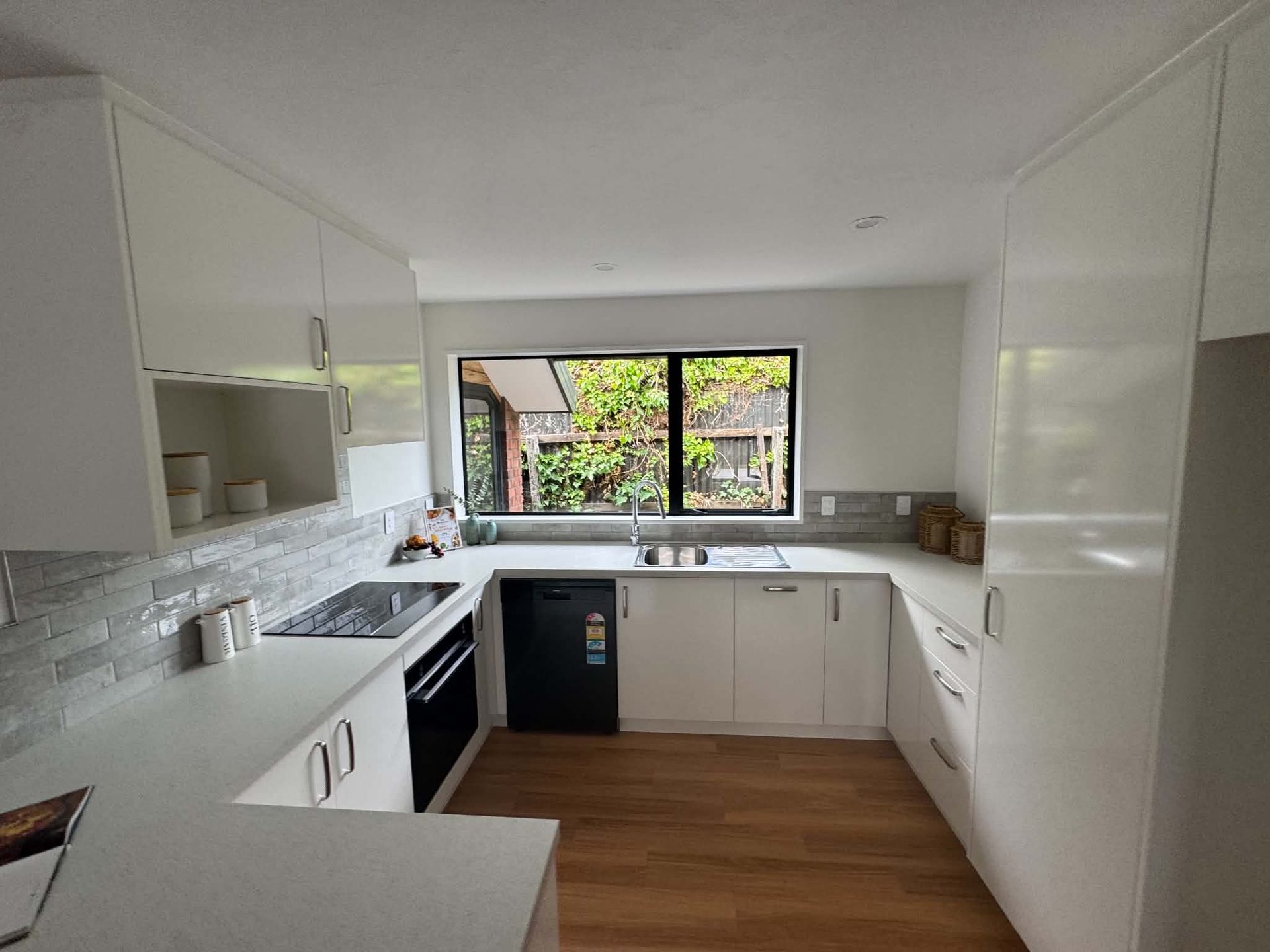 Bright white repainted kitchen interior with timber floor