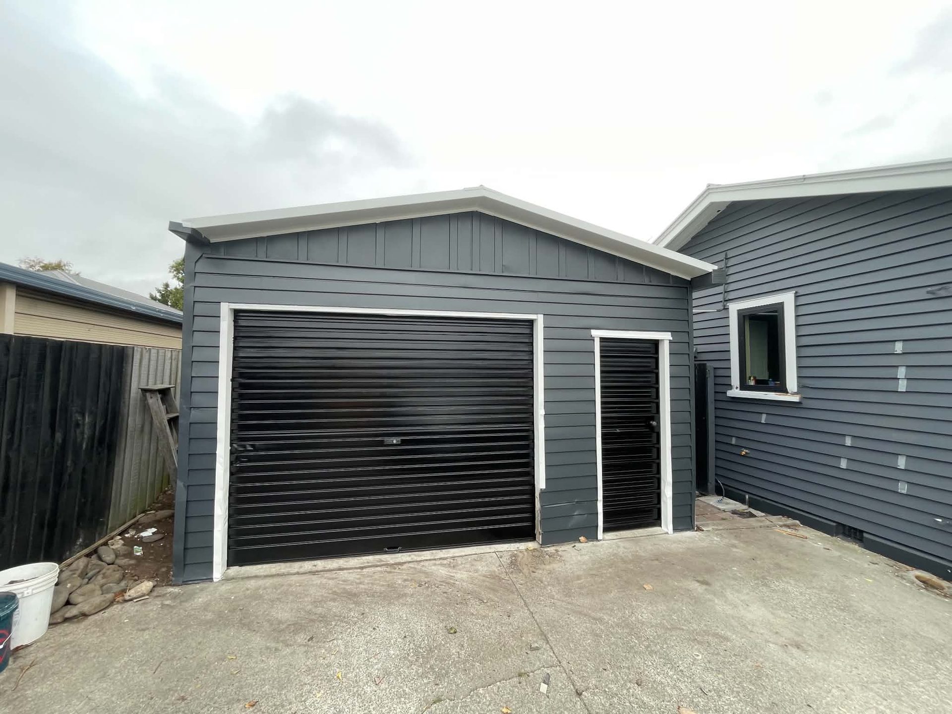 Grey repainted garage and weatherboard exterior